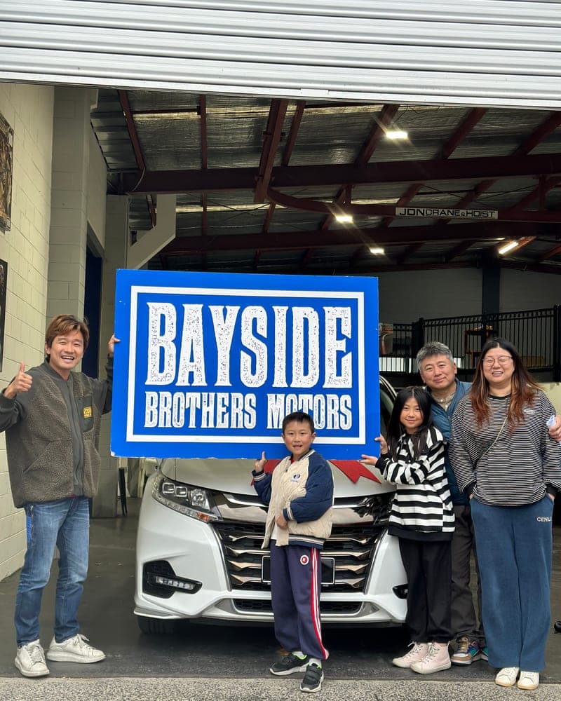 A customer picking up their car at Bayside Brothers Motors