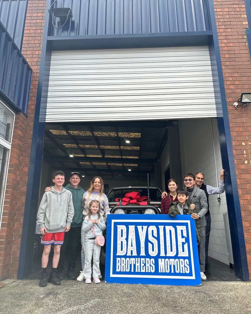 A customer picking up their car at Bayside Brothers Motors