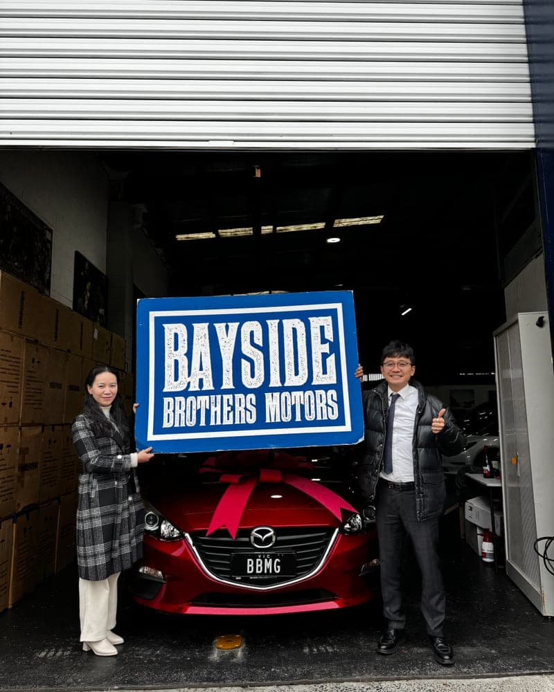 A customer picking up their car at Bayside Brothers Motors