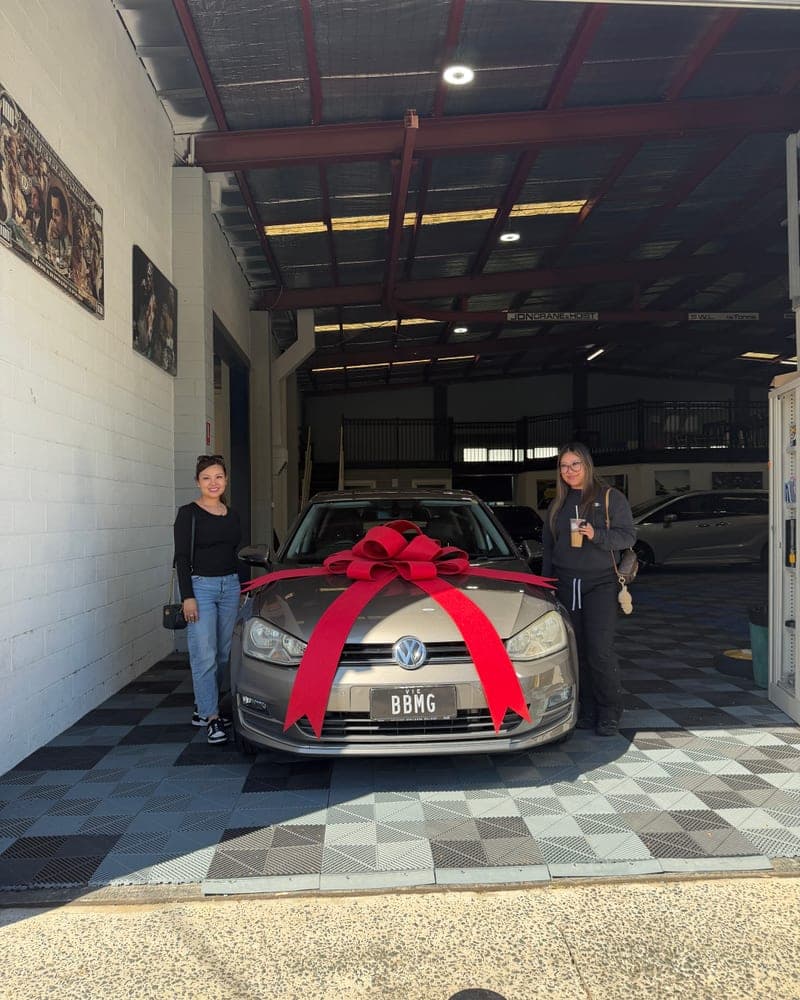 A customer picking up their car at Bayside Brothers Motors