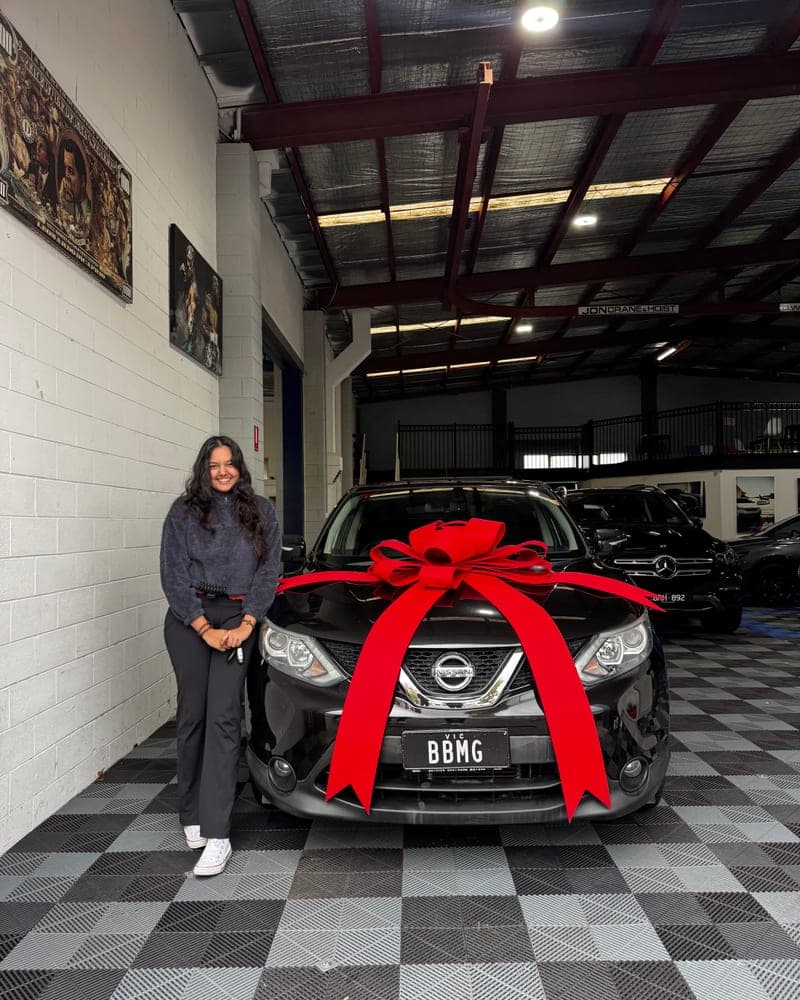 A customer picking up their car at Bayside Brothers Motors