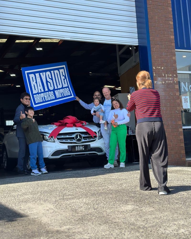 A customer picking up their car at Bayside Brothers Motors