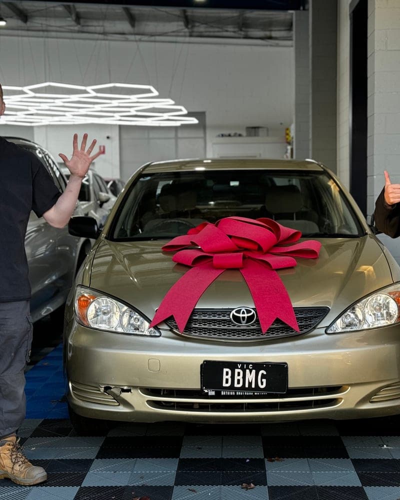 A customer picking up their car at Bayside Brothers Motors