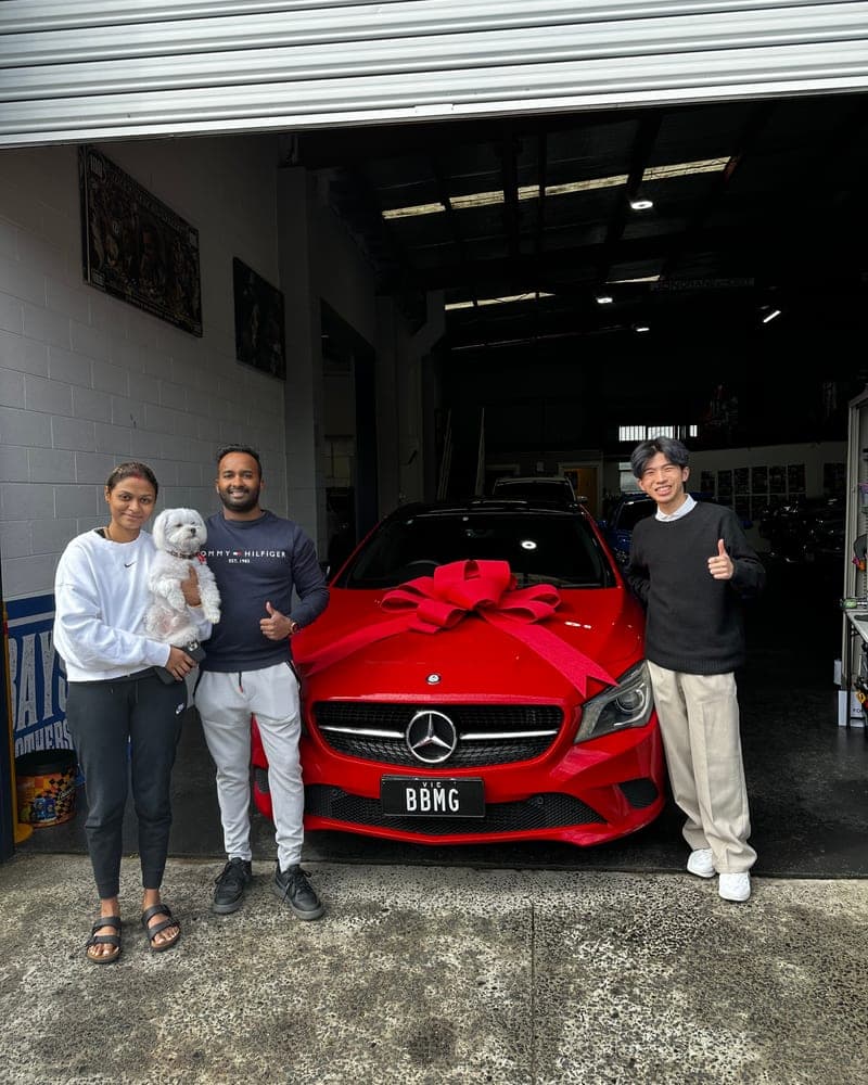 A customer picking up their car at Bayside Brothers Motors