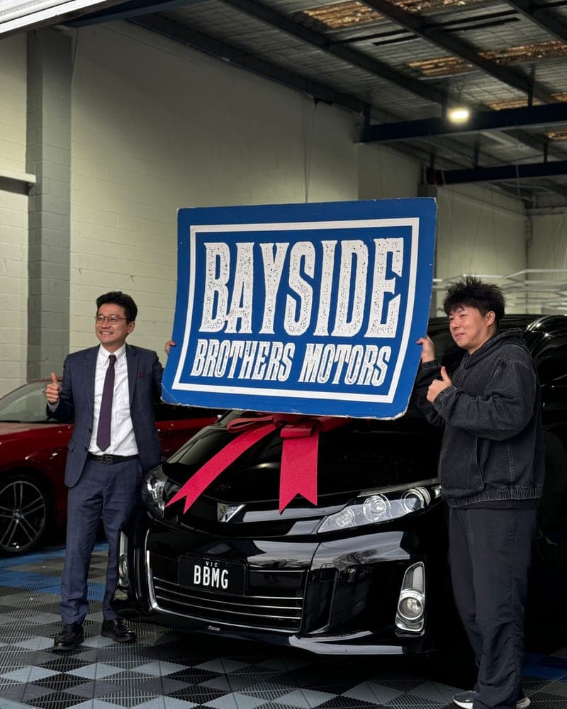 A customer picking up their car at Bayside Brothers Motors