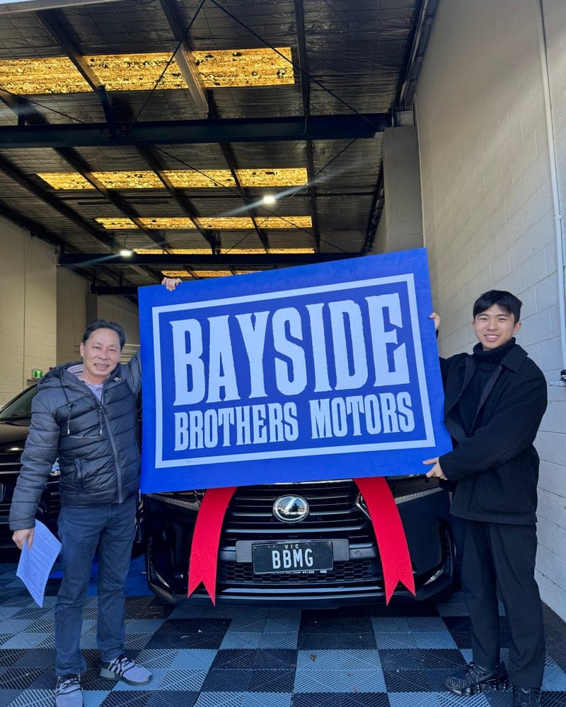 A customer picking up their car at Bayside Brothers Motors