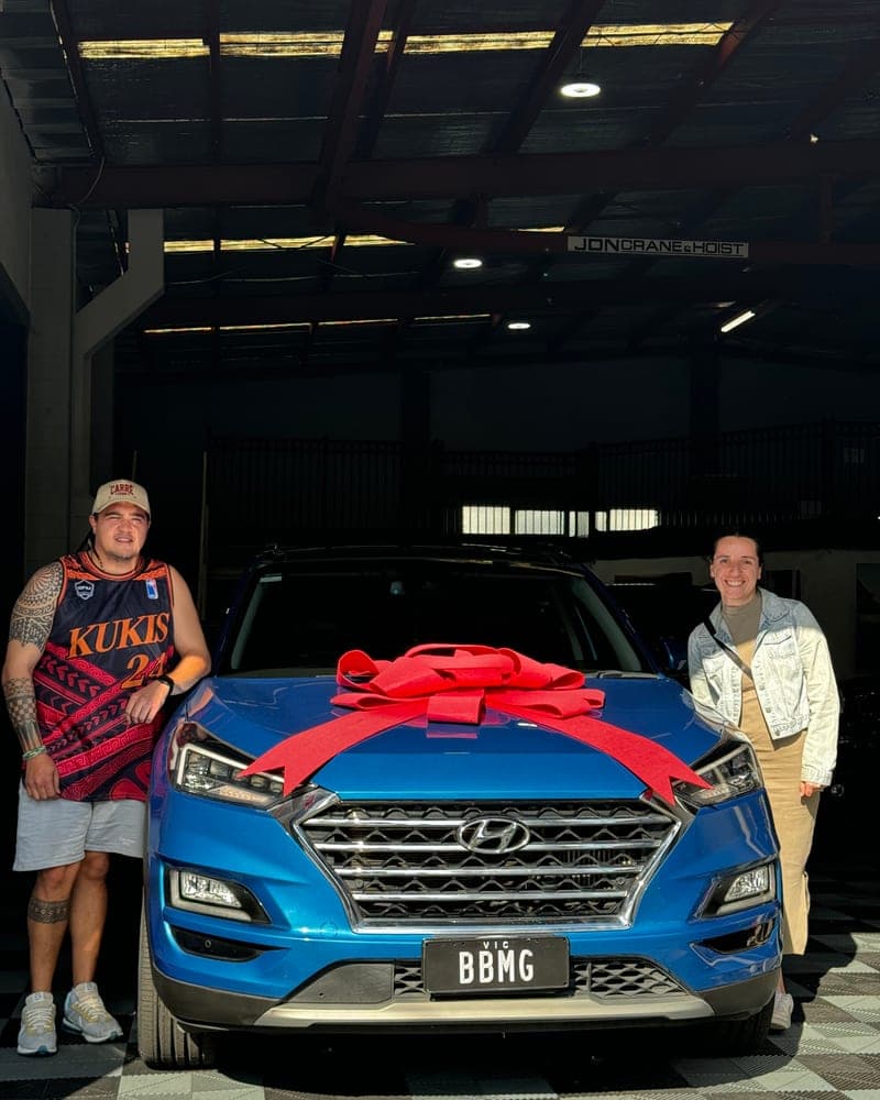 A customer picking up their car at Bayside Brothers Motors