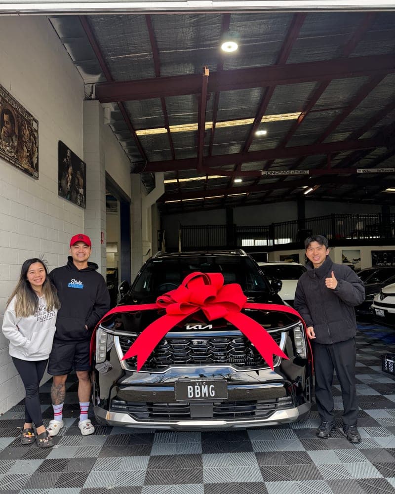 A customer picking up their car at Bayside Brothers Motors