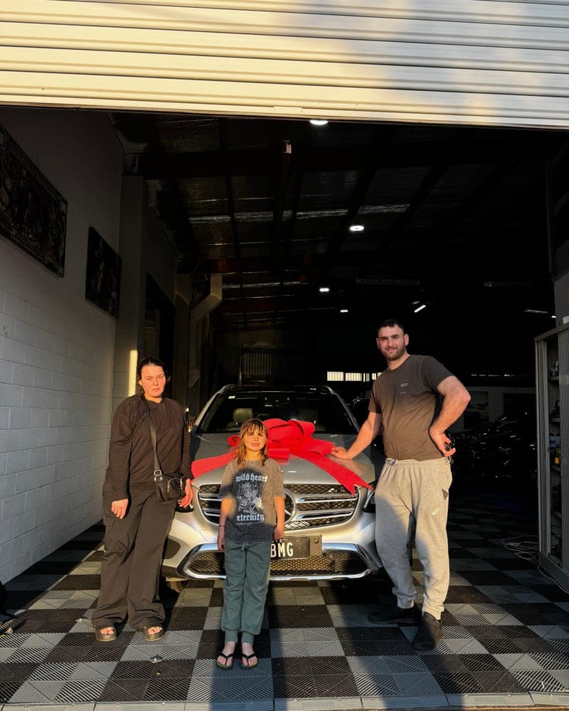 A customer picking up their car at Bayside Brothers Motors