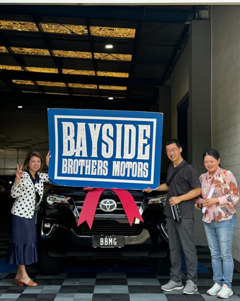 A customer picking up their car at Bayside Brothers Motors
