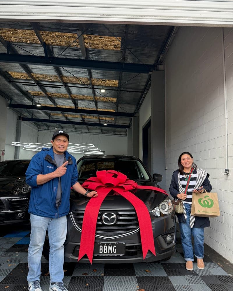 A customer picking up their car at Bayside Brothers Motors