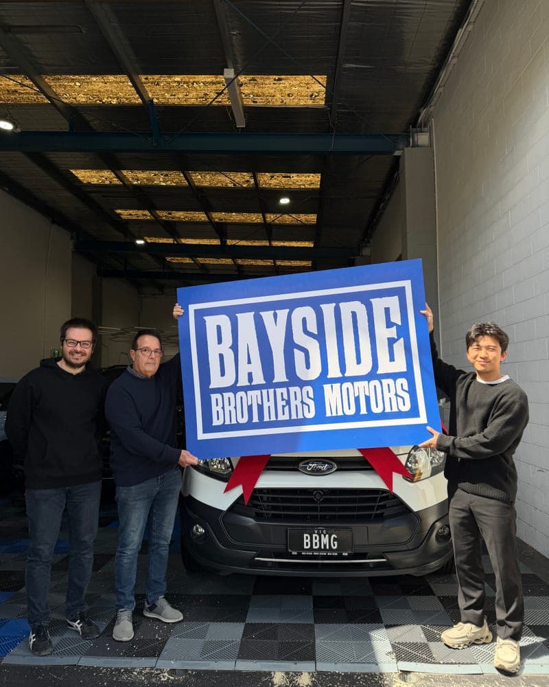 A customer picking up their car at Bayside Brothers Motors