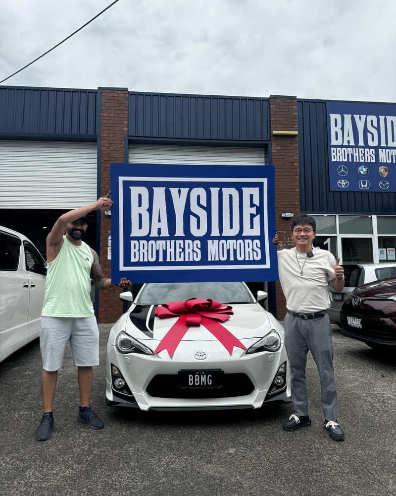 A customer picking up their car at Bayside Brothers Motors
