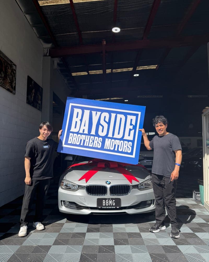 A customer picking up their car at Bayside Brothers Motors