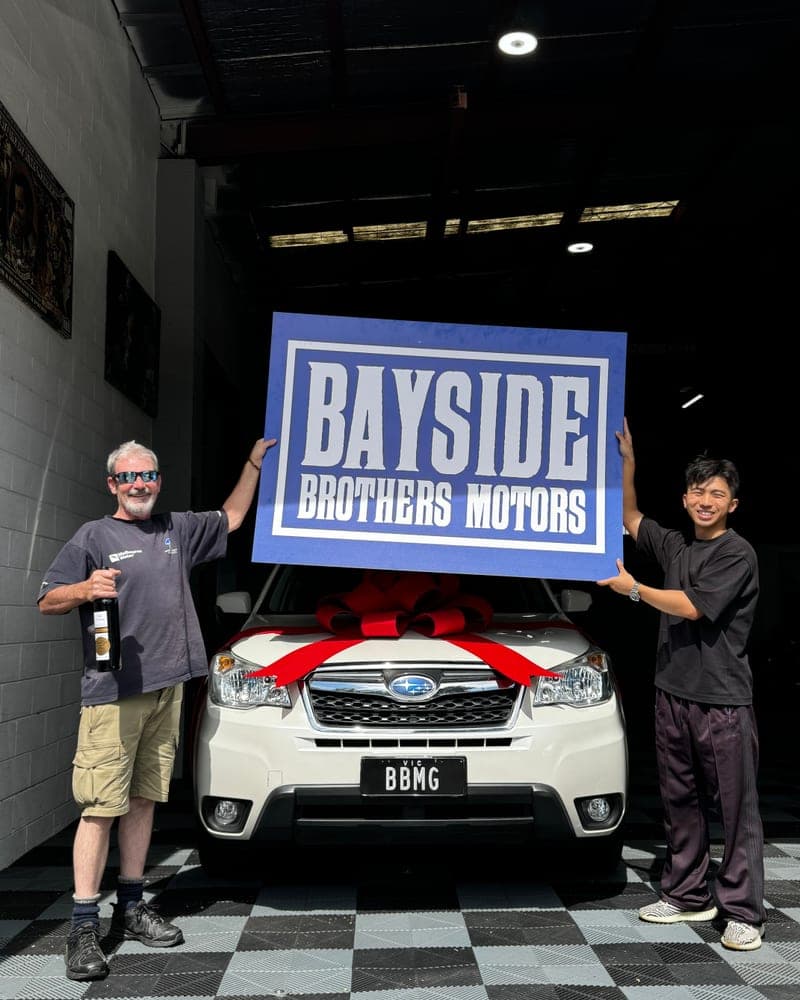 A customer picking up their car at Bayside Brothers Motors