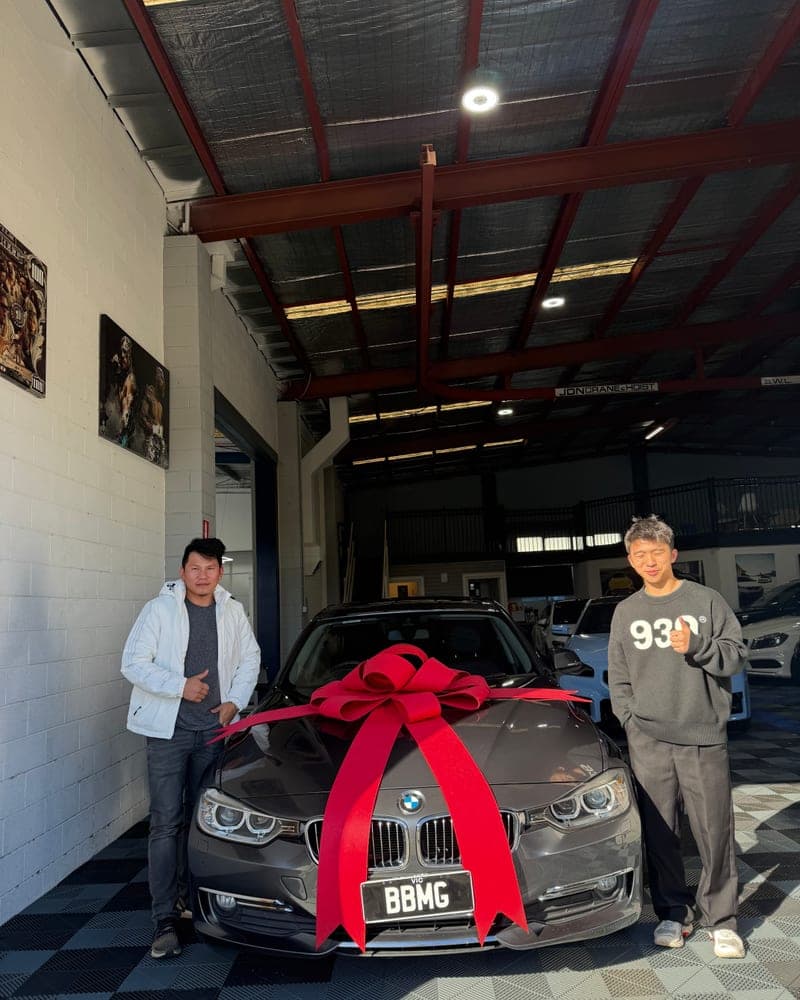 A customer picking up their car at Bayside Brothers Motors