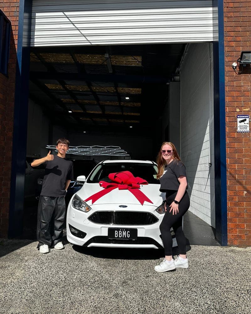 A customer picking up their car at Bayside Brothers Motors