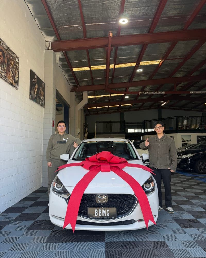 A customer picking up their car at Bayside Brothers Motors