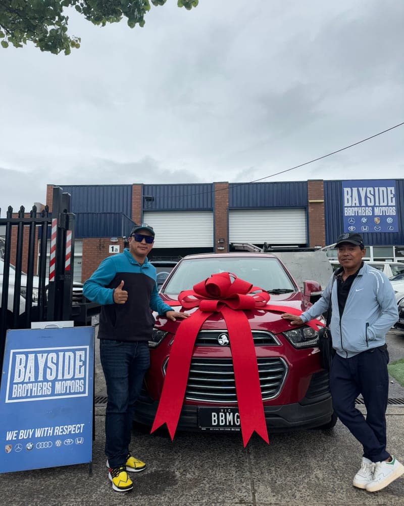 A customer picking up their car at Bayside Brothers Motors
