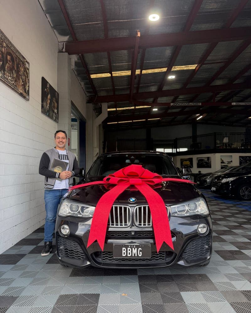 A customer picking up their car at Bayside Brothers Motors