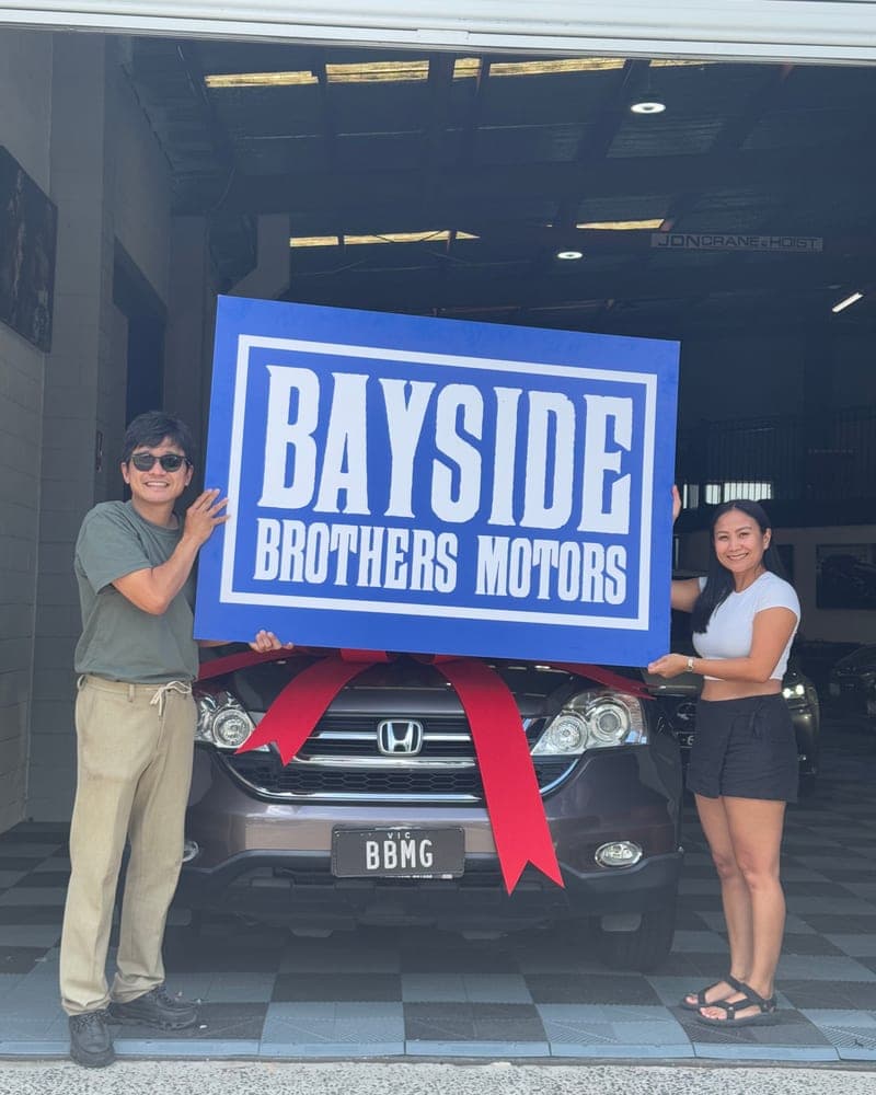 A customer picking up their car at Bayside Brothers Motors