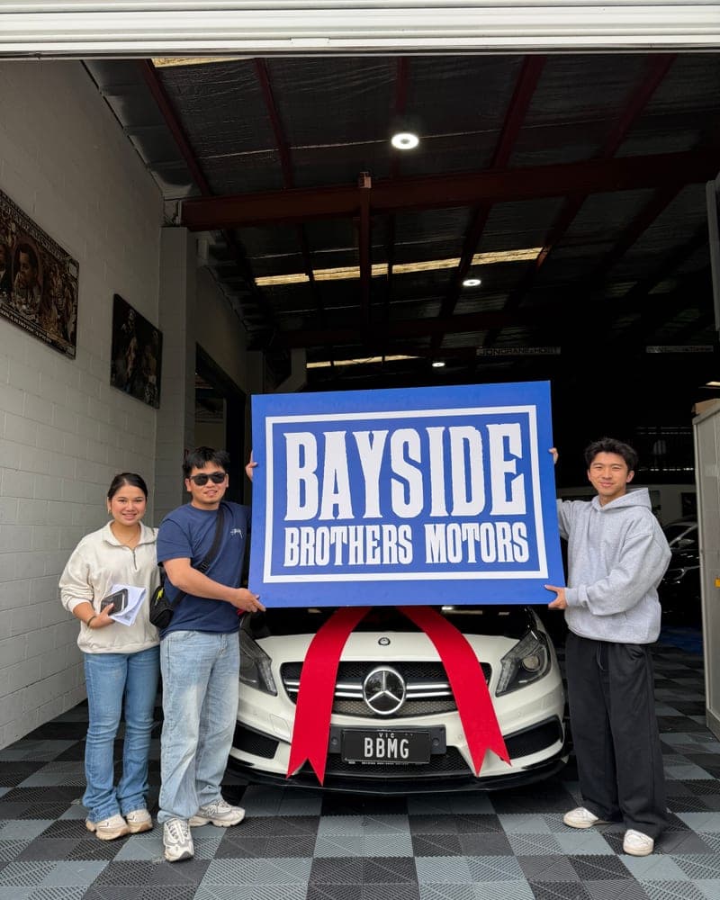 A customer picking up their car at Bayside Brothers Motors