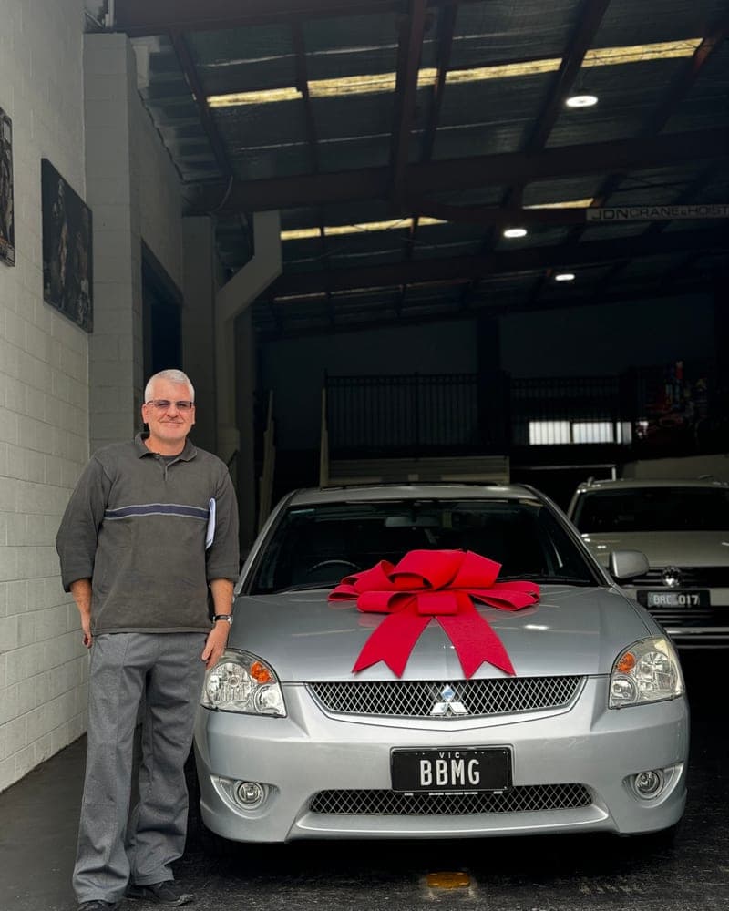 A customer picking up their car at Bayside Brothers Motors