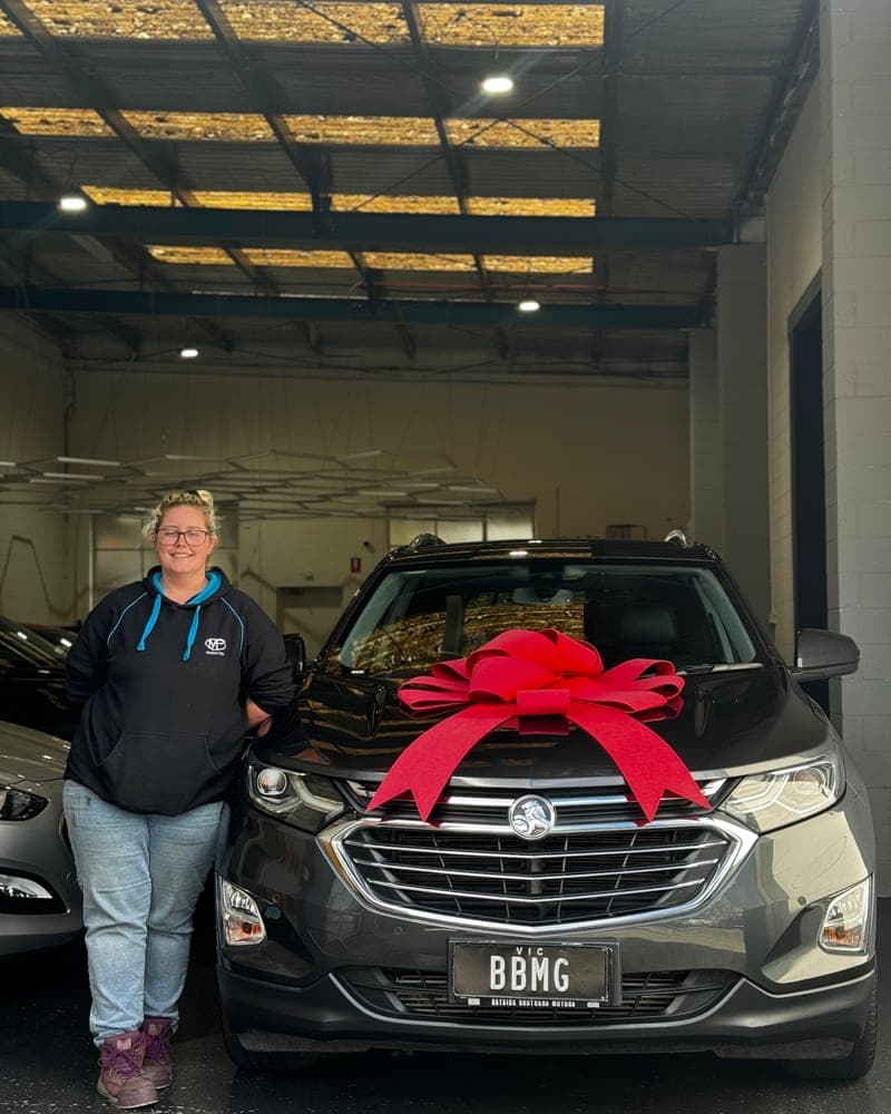 A customer picking up their car at Bayside Brothers Motors
