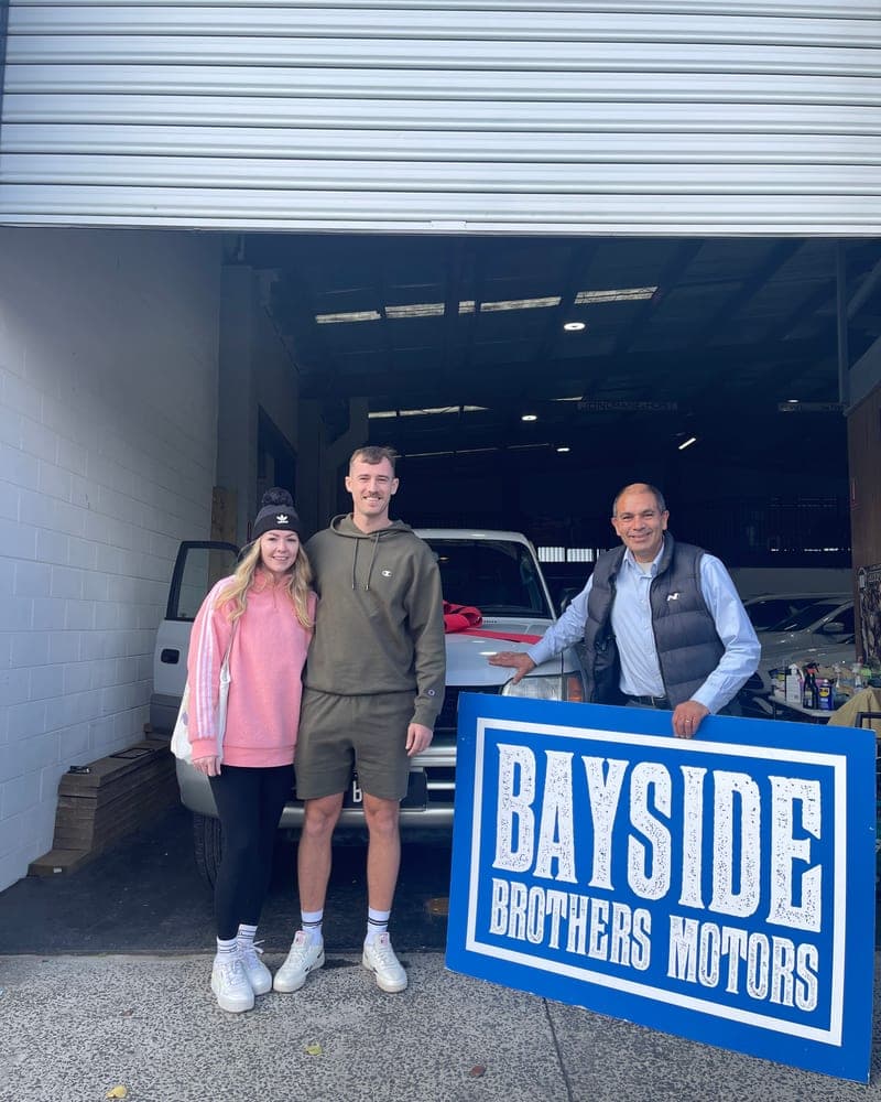 A customer picking up their car at Bayside Brothers Motors