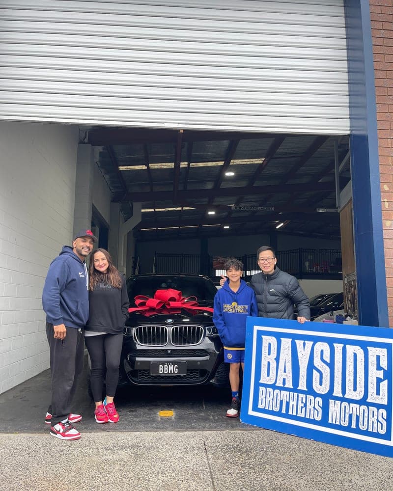 A customer picking up their car at Bayside Brothers Motors