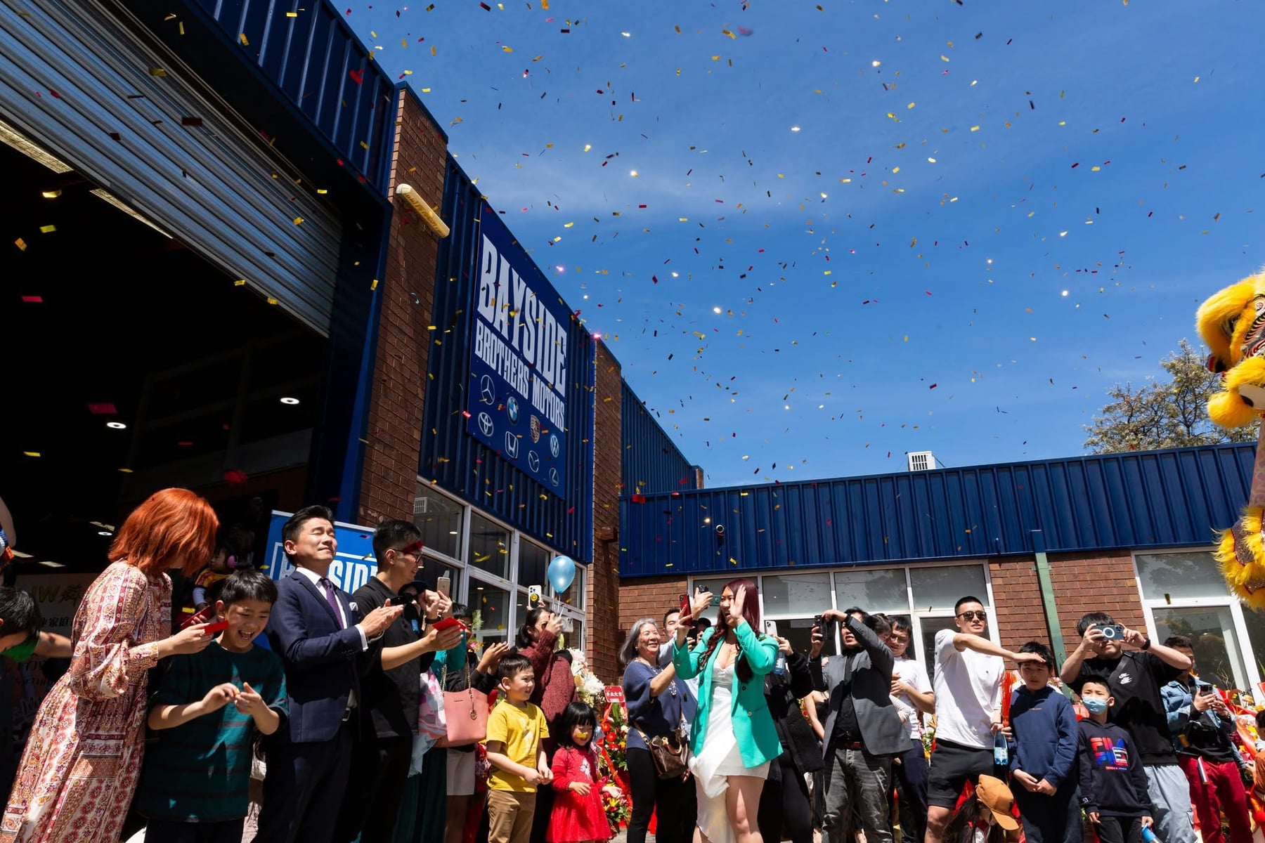 Confetti and a crowd outside Bayside Brothers Motors on opening day