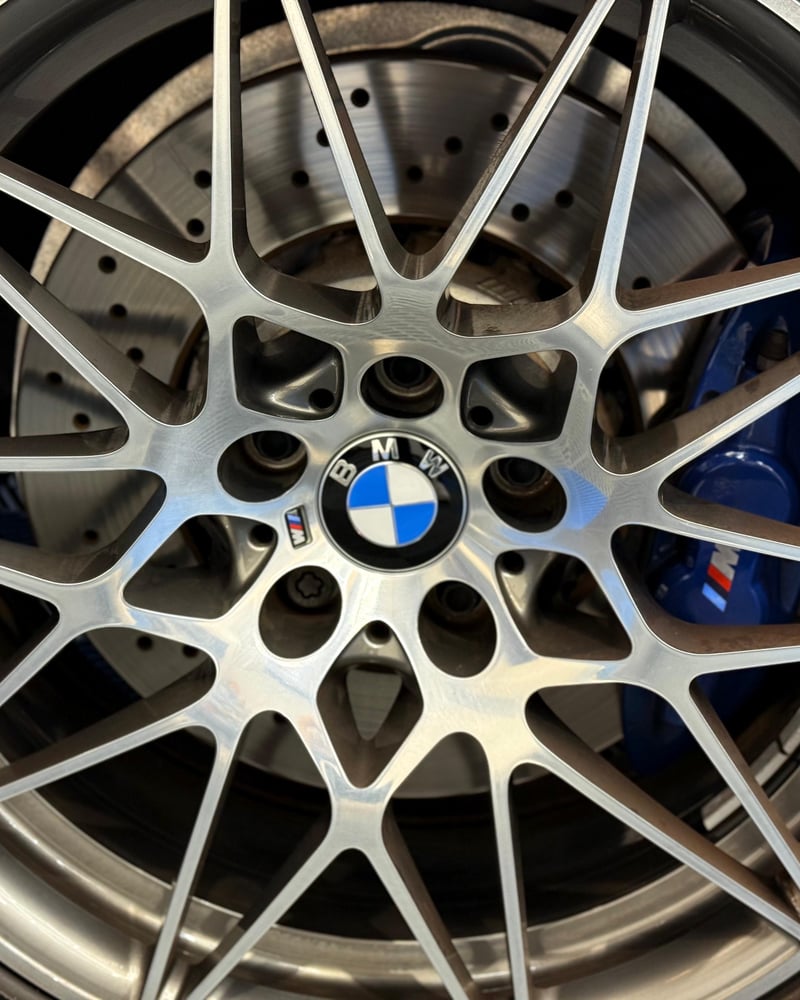 A BMW M alloy wheel and brake caliper, close up